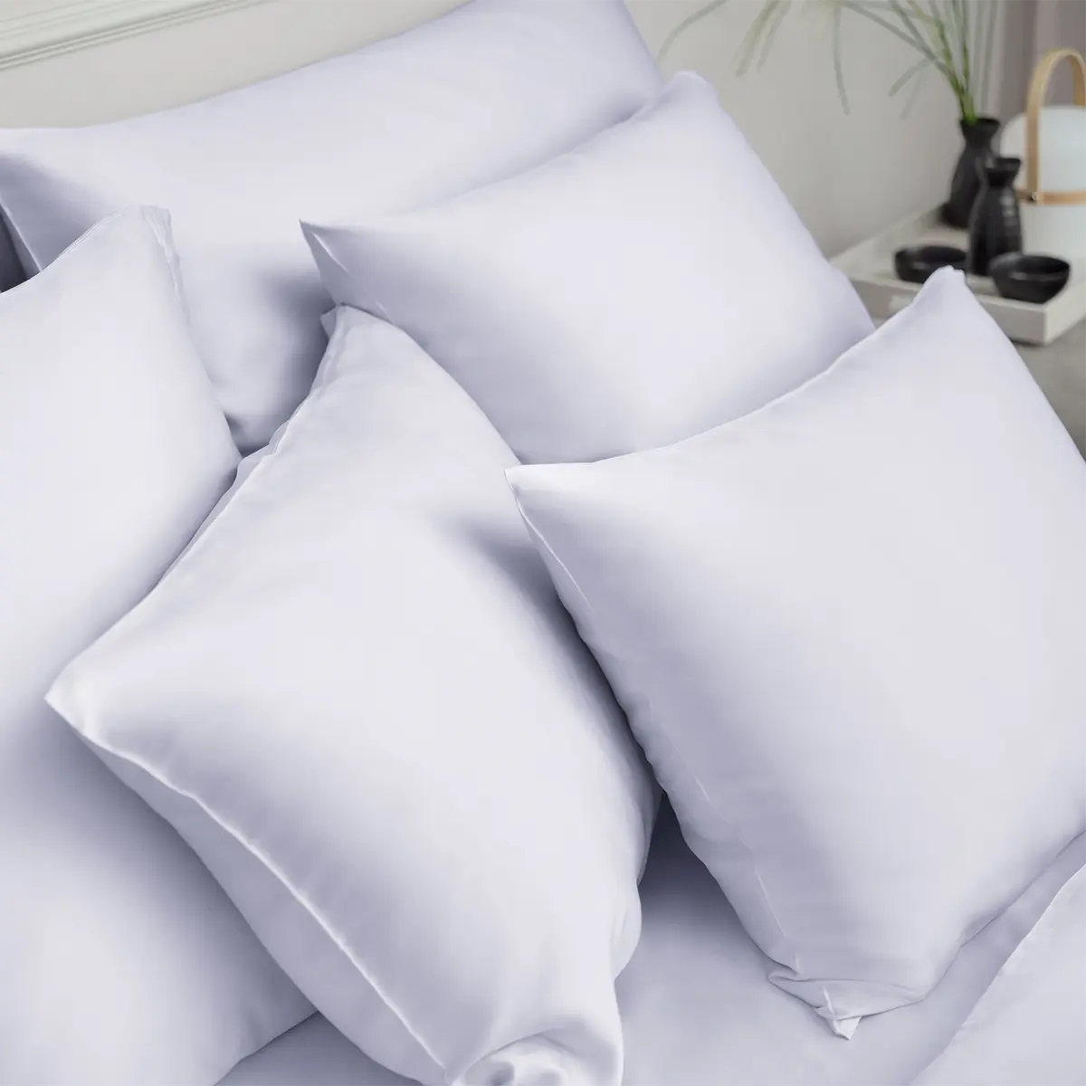 Stapel von Kissen mit Micromodal Bettwäsche in Glace Mehrere Kissen mit Micromodal Bettwäsche in der Farbe Glace, die übereinander gestapelt sind und eine luxuriöse, weiche Textur zeigen.